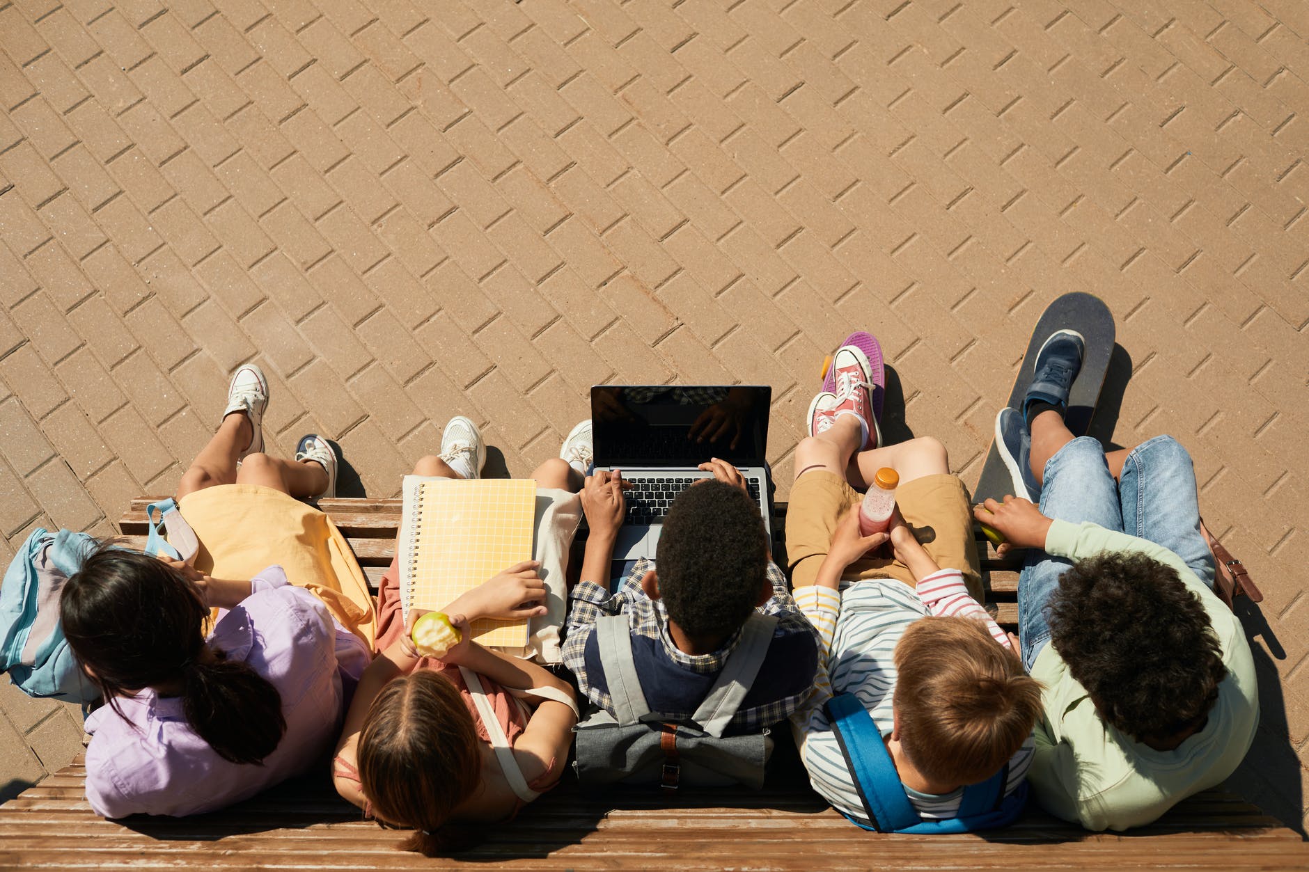 classmates sitting on a bench